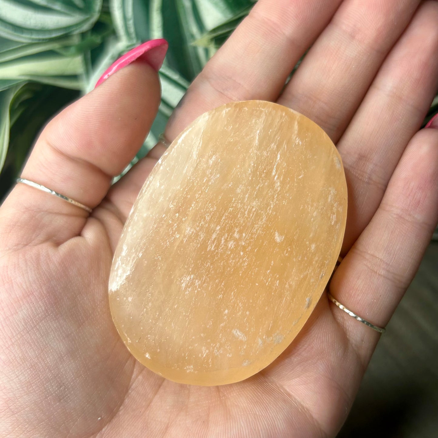 peach selenite palm stone