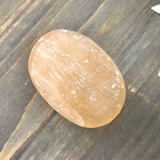 peach selenite palm stone