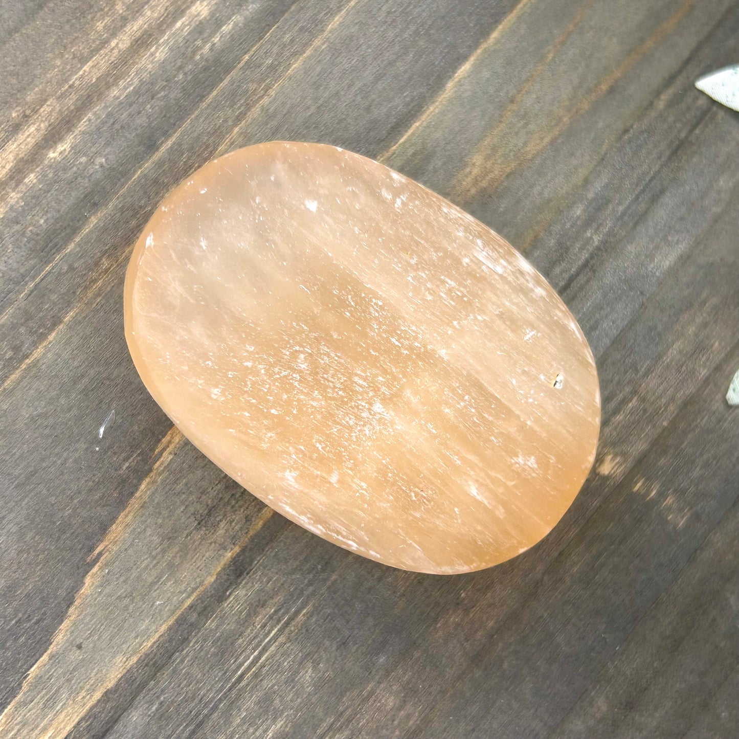 peach selenite palm stone