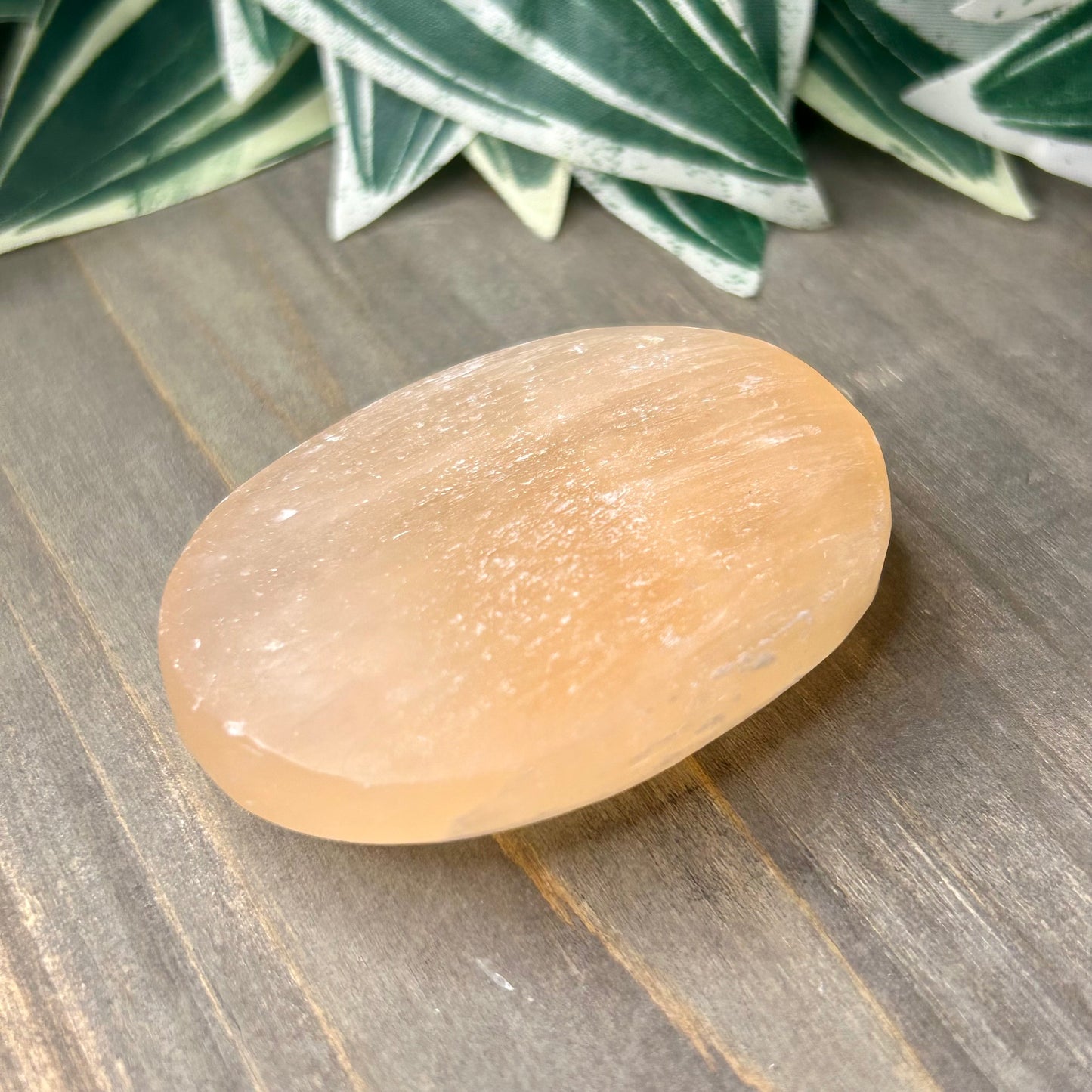 peach selenite palm stone